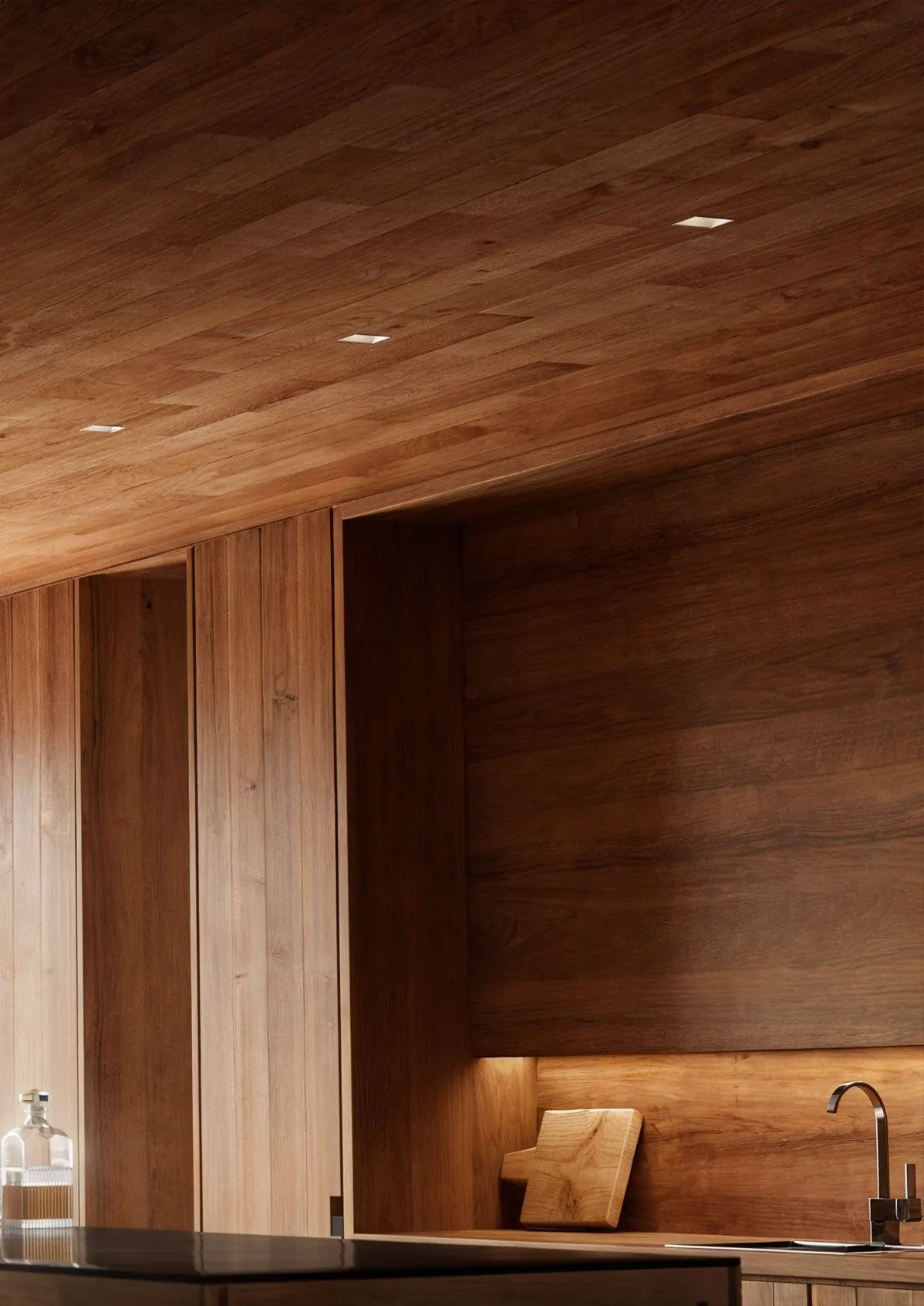 Wood-paneled wall and ceiling with small recessed downlights