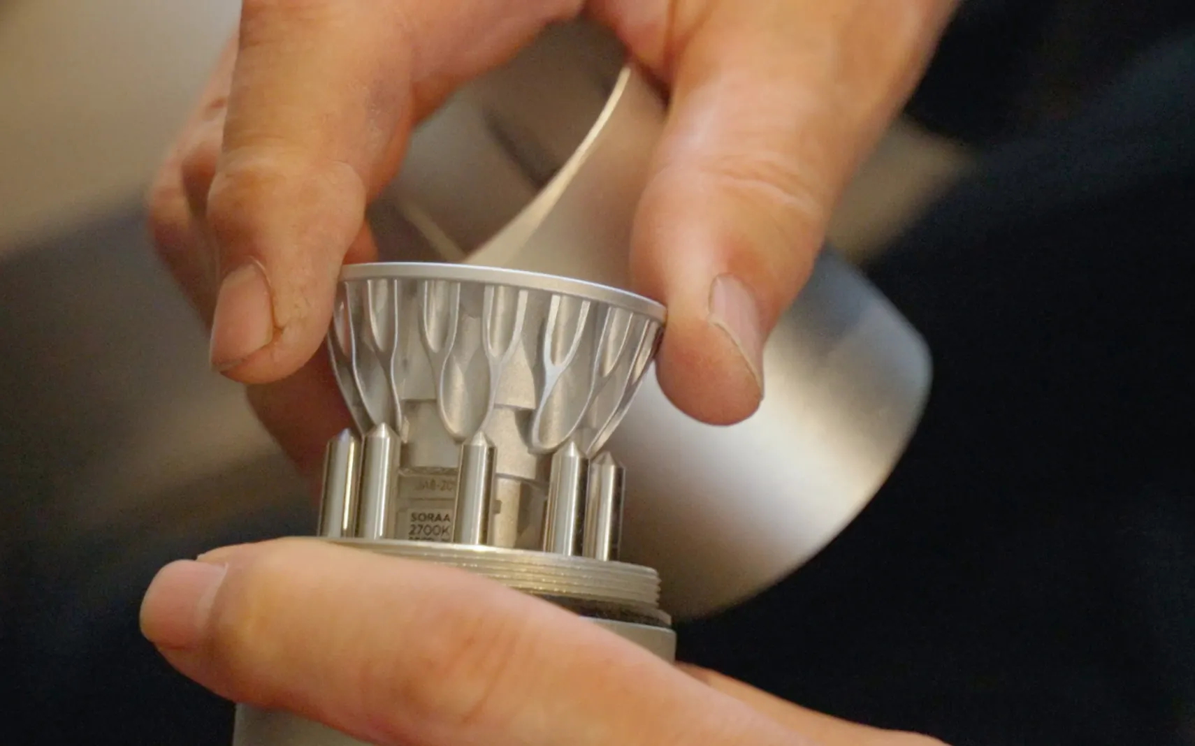 Hands changing the LED module of an HK accent light