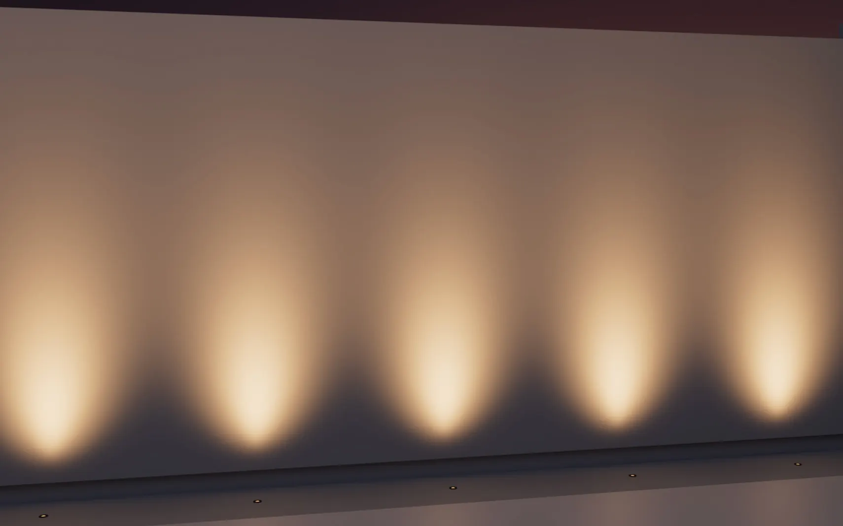 Row of in-grade lights casting even scallops up a wall