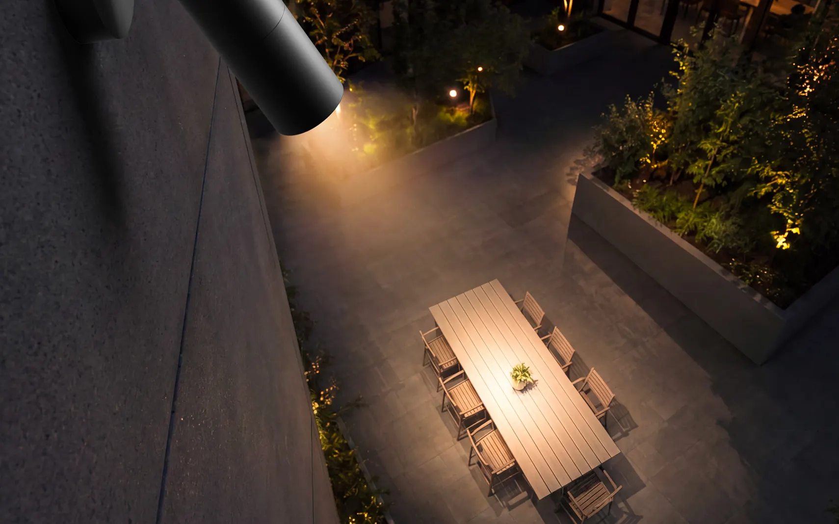 HK Sentinel area light over a dining terrace at night