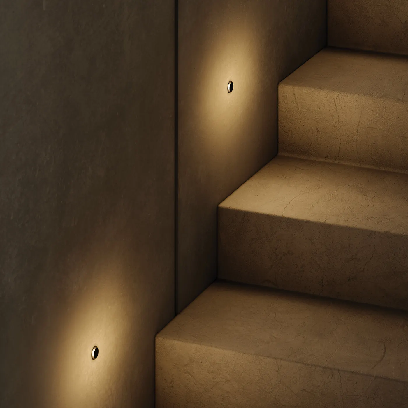 Stone stairs lit by small recessed step lights